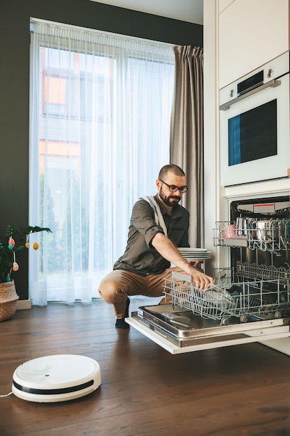 Bearded man unloading dishwasher