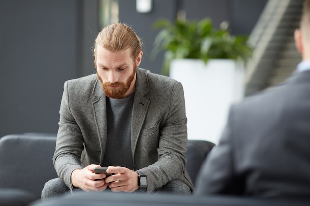 Bearded man using internet app