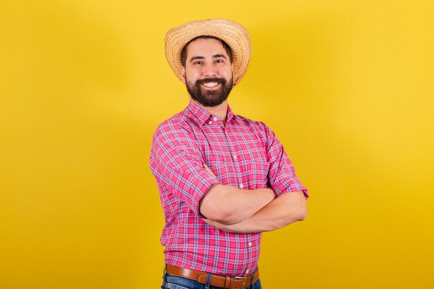 Bearded man wearing typical clothes for party Junina Arms crossed smiling optimistic Closeup photo