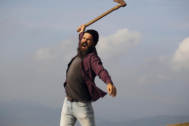 Bearded man with ax on mountain