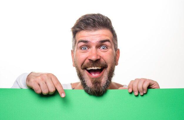 Bearded man with blank sign board handsome man presenting empty advertising banner smiling man shows