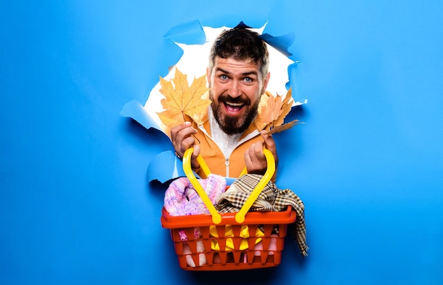 Bearded man with shopping basket preparing for autumn sale discount black friday supermarket