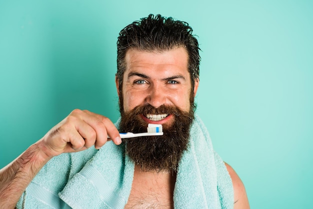 Bearded man with tooth brush tooth paste morning treatments morning routine in bathroom health care