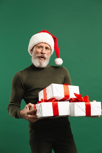 Bearded modern Santa Claus holding gifts