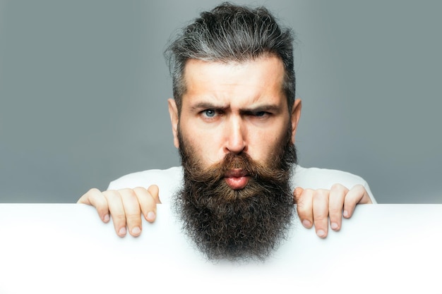 Bearded surprised man with paper