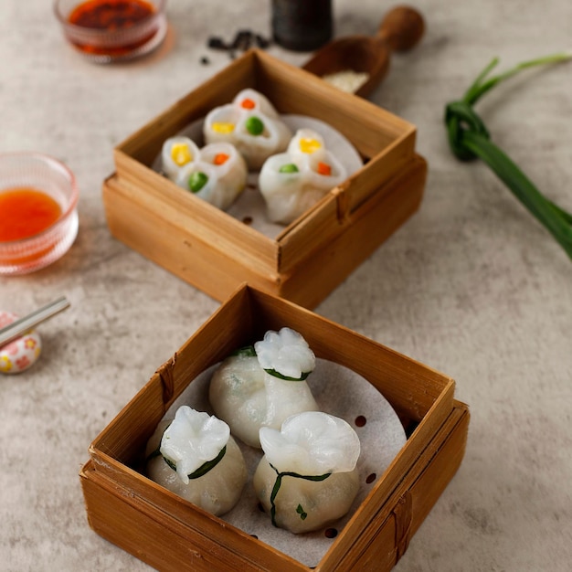 Beatiful Hongkong Style Steamed Chives Dumplings on the Rustic Cement Table. Called Gu Chai in Thau and in Chinese called Jiu Cai Jiao, Thai Chinese Appetizer