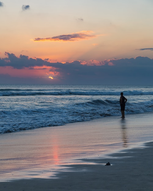 Beatiful sunset and silhouette of a man on Seminyak beach, Bali