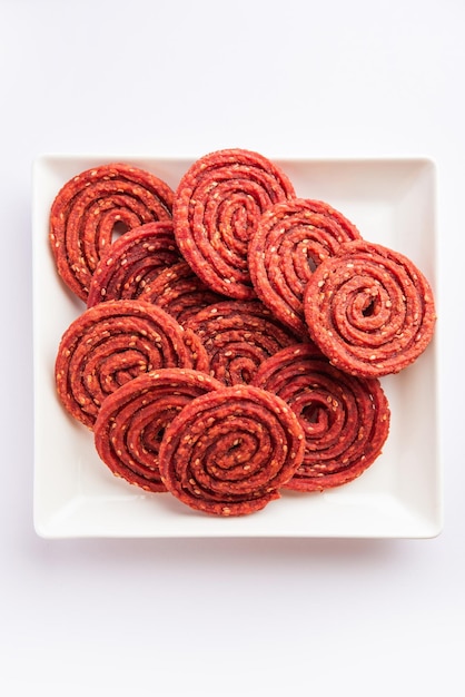 Beatroot chakli murukku Beetroot chakli a spiral fried snack from India made in Diwali festival