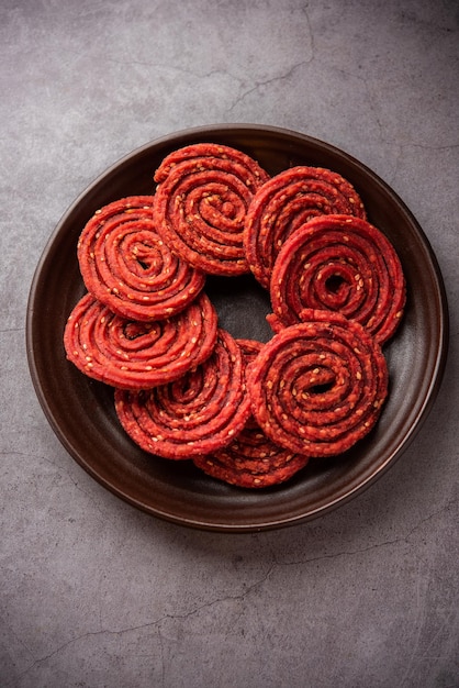 Beatroot chakli murukku Beetroot chakli a spiral fried snack from India made in Diwali festival