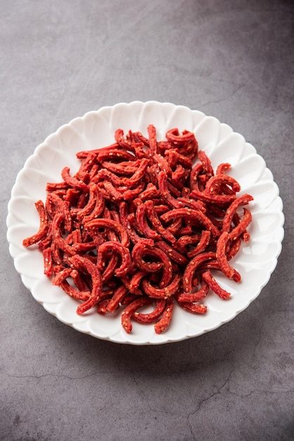 Beatroot chakli sticks made using beetroot fried tea time snack from India