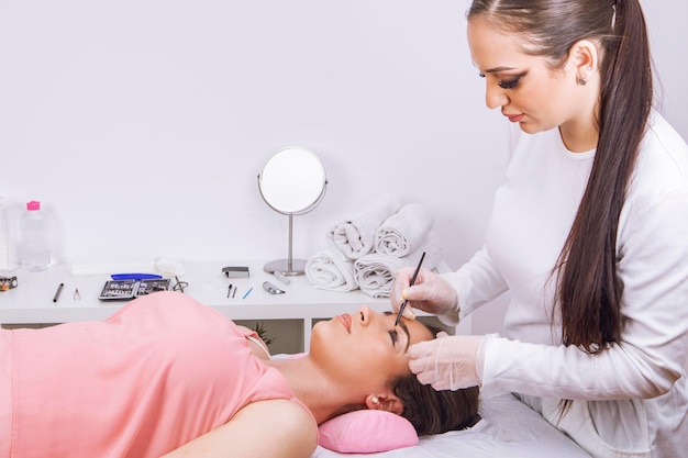 Beautician applying the eyelash lifting treatment