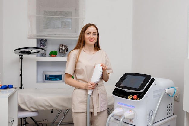 Beautician holding ultrasound device for face and skin lifting procedure and hair removal Young woman cosmetologist using modern cosmetology equipment in clinic