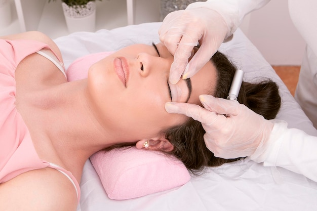 Beautician preparing the eyelid for the eyelash lifting procedure