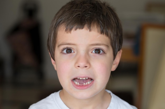 Beautiful 6 years old boy showing teeth