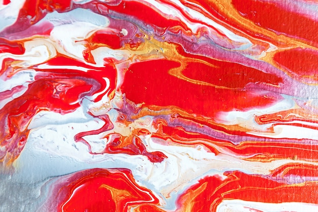 A beautiful acrylic background in red and blue colors. Abstract colorful texture, wallpaper, background for design and creativity. Mixing colors, modern art. Fluid art.