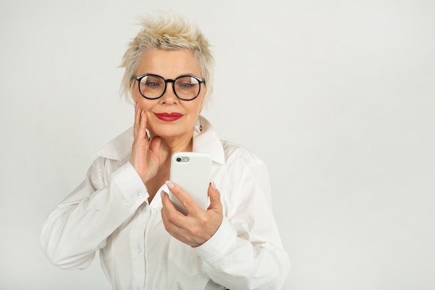 beautiful adult woman in glasses with a mobile phone