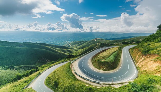 Photo beautiful aerial view of the winding road through lush green hills and clear skies