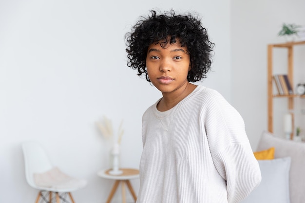 Beautiful african american girl with afro hairstyle at home indoor young african woman with curly ha