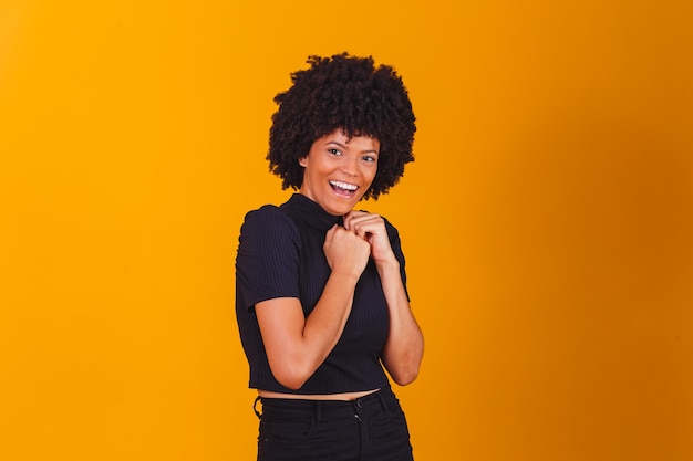 Beautiful african american girl with an afro hairstyle smiling. Woman with black power hair