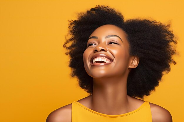 Beautiful african american woman with afro hairstyle on yellow background