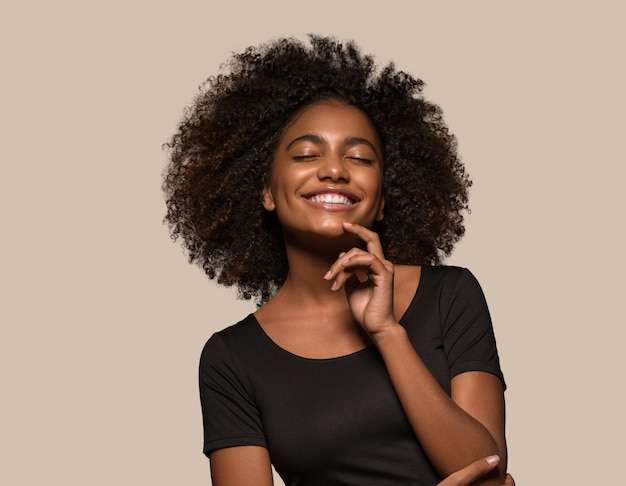 Beautiful african woman black t-shirt portrait afro haircut touching her face Color background brown