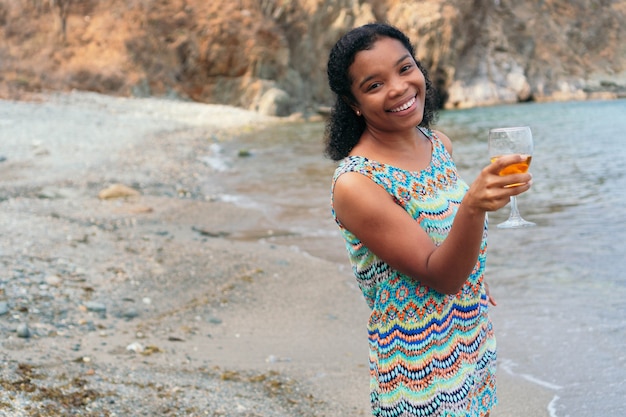 Beautiful African woman holding a glass of wine