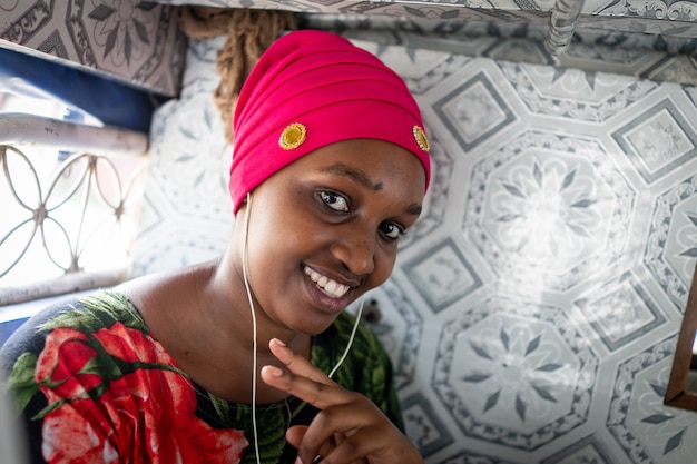 Beautiful african young woman traveling in small bus