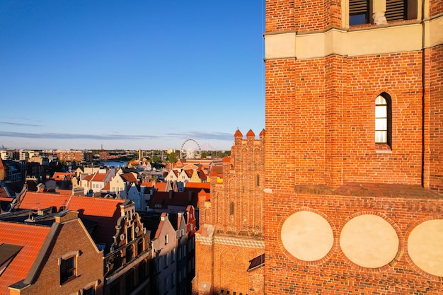 Beautiful architecture of old town in Gdansk Poland at sunny day Aerial view from drone of the Main Town Hall and St Mary Basilica City Architecture from Above Europe