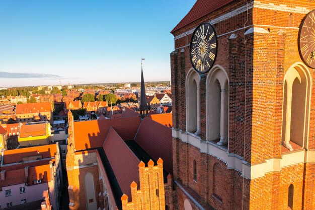 Beautiful architecture of old town in Gdansk Poland at sunny day Aerial view from drone of the Main Town Hall and St Mary Basilica City Architecture from Above Europe