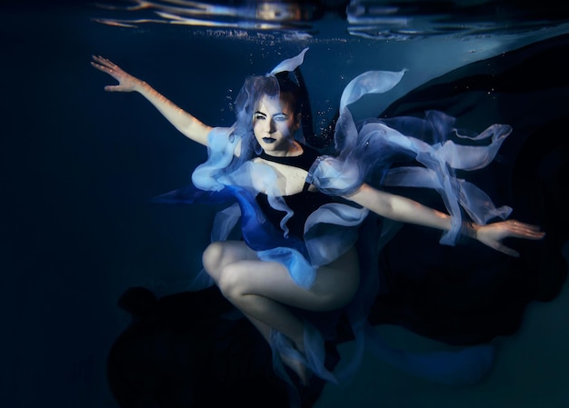 beautiful artistic young woman dancing underwater. Mermaid, dance, fairy concept