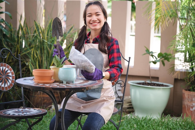 Beautiful Asia woman plant in the tree pot in the garden