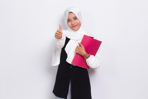 beautiful asian business muslim woman hug a book fist and tumb up ok isolated on white background