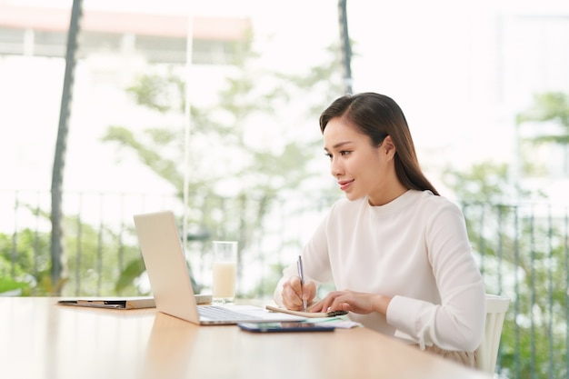 Beautiful asian businesswoman using a laptop computer