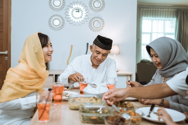 Beautiful asian family enjoying their iftar dinner at home. ramadan kareem islam break fasting tradition