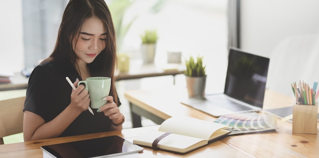 Beautiful Asian freelancer working on her project 