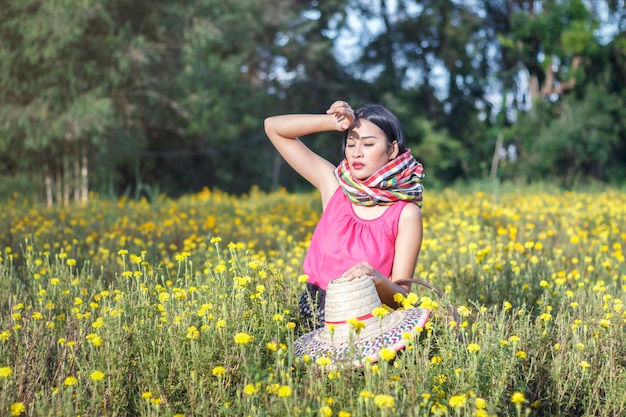 Beautiful asian gardener girl in marigold flowers field 