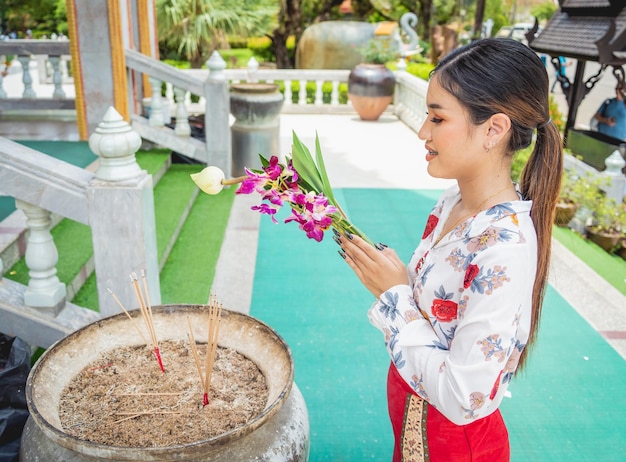 Beautiful Asian girl at big Buddhist temple dressed in traditional costume