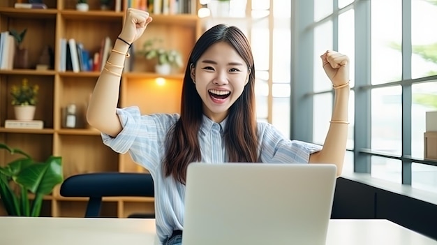 Beautiful Asian girl celebrate with laptop success happy pose Ecommerce university education internet technology or startup small business concept Modern office or living room with copy space