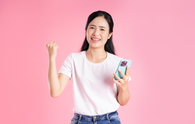 Beautiful asian girl portrait isolated on pink background