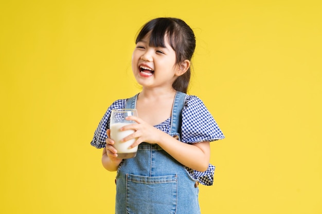 Beautiful asian girl portrait isolated on yellow background