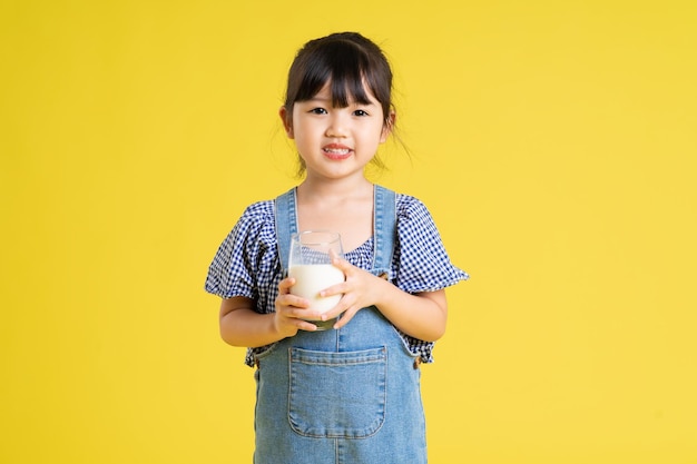 Beautiful asian girl portrait isolated on yellow background