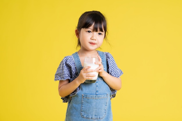 Beautiful asian girl portrait isolated on yellow background