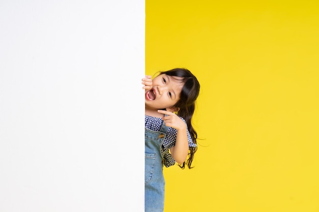 Beautiful asian girl portrait isolated on yellow background