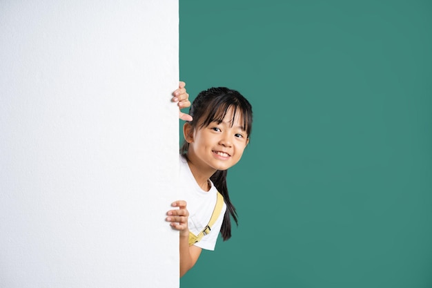 Beautiful asian girl posing on blue background