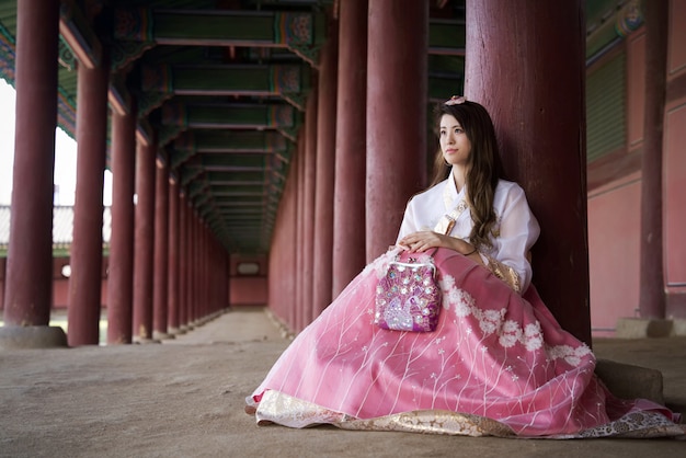 Beautiful Asian girl with South Korea traditional Hanbok style dress sitting with smile