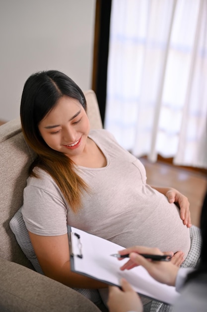 Beautiful Asian pregnant woman has an appointment with her doctor