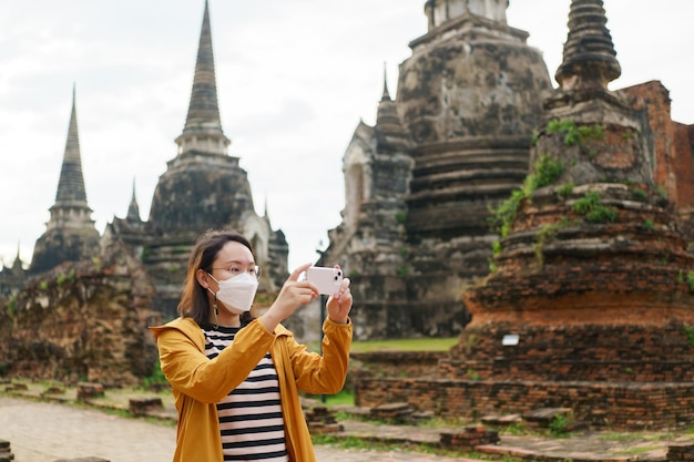 Beautiful Asian tourists Walking taking photos and traveling on holidays The old town world heritage city Ayutthaya kingdom Phra Nakhon Si Ayutthaya Thailand