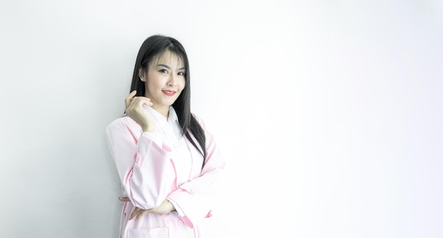 Beautiful Asian woman doctor with copy space on white background Asian woman doctor in uniform pink coat Medical and healthcare