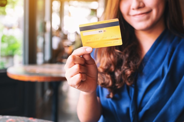 A beautiful asian woman holding credit card for shopping