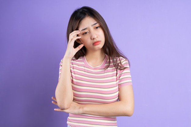 Beautiful asian woman portrait, isolated on purple background